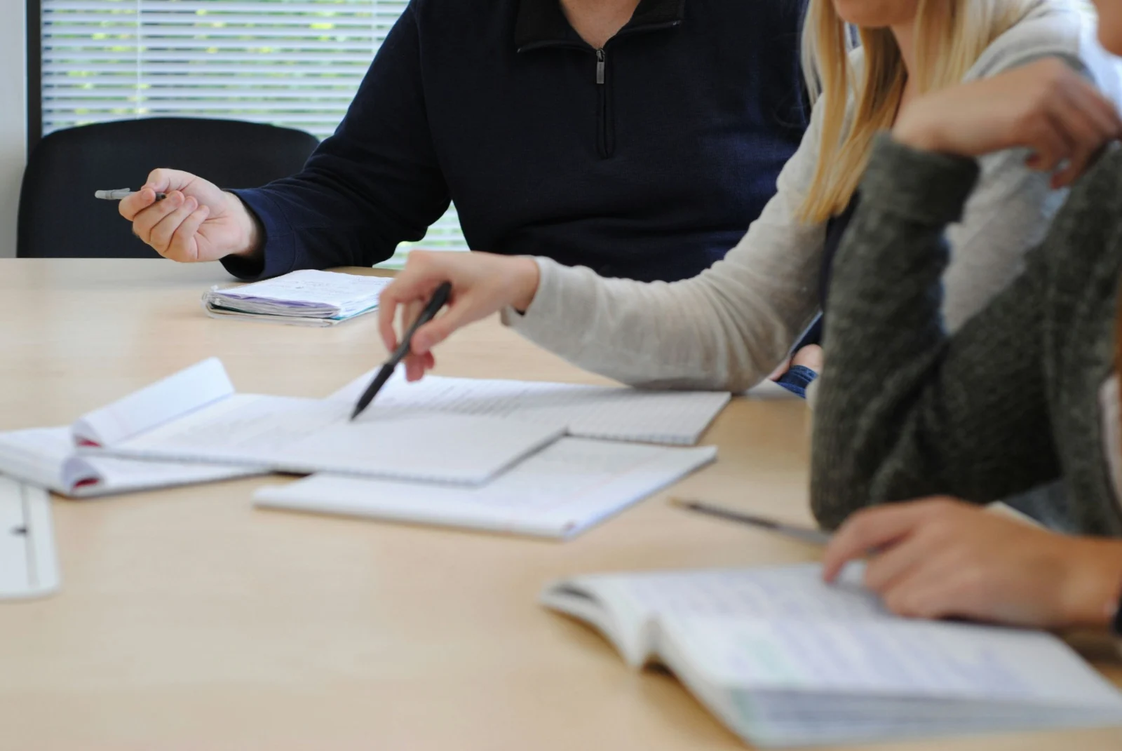 Staff around a table with notes, planning together.